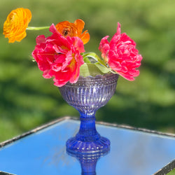 lavender lue mercury glass chalice with flowers on mirrored table